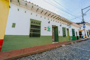 a building with green and white on a street at Selva María Hotel Boutique in Santa Fe de Antioquia +56 photos