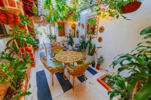 a room with a table and chairs and plants at Selva María Hotel Boutique in Santa Fe de Antioquia