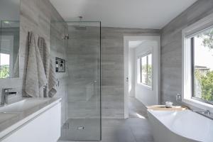 a bathroom with a shower and a tub and a sink at An Unforgettable View in Dixons Creek +45 photos