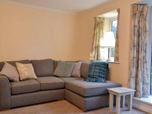 a living room with a couch and a window at The Mill Cottage in Ault Hucknall