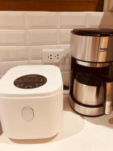 a coffee maker sitting on a counter next to a coffee pot at Casa Yvanna in Alfonso