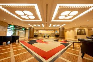 a lobby with a large rug on the floor at Jasmac Plaza Hotel in Sapporo