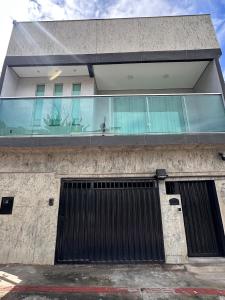 a building with two garage doors and a window at Gold Stay Residence 2 in Belo Horizonte