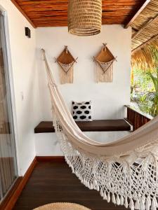 a hammock in the porch of a house at Villa Sairé in Alter do Chao