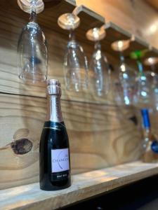 a bottle of wine sitting on a counter with wine glasses at Gold Stay Residence 2 in Belo Horizonte