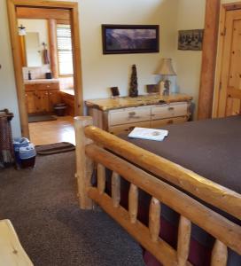 a bedroom with a table and a bench in a room at Nature's Inn Bed and Breakfast in Ahwahnee +35 photos