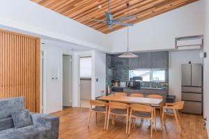 a kitchen and dining room with a table and chairs at Myoko Cedric Villa 01 in Myoko