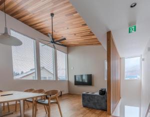 a dining room and living room with a table and chairs at Myoko Cedric Villa 01 in Myoko