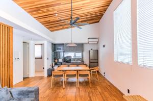 a dining room with a table and a ceiling fan at Myoko Cedric Villa 01 in Myoko +2 photos