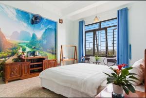 a bedroom with a large painting on the wall at Tam Coc Guest House & Hostel in Ninh Binh +36 photos