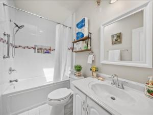 a white bathroom with a toilet and a sink at May House in Washington, D.C. +7 photos