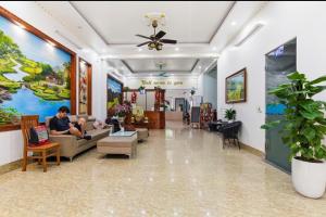a lobby of a hospital with people sitting on couches at Tam Coc Guest House & Hostel in Ninh Binh