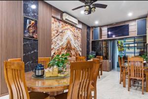 a dining room with a wooden table and chairs at Tam Coc Guest House & Hostel in Ninh Binh