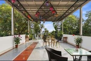 a patio with tables and chairs and a chandelier at Tam Coc Guest House & Hostel in Ninh Binh