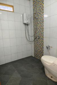 a bathroom with a shower and a toilet in it at Villa Argapuri Hills in Ciwidey