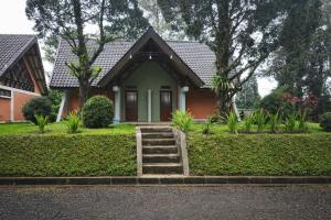 a small house with a staircase in front of it at Villa Argapuri Hills in Ciwidey