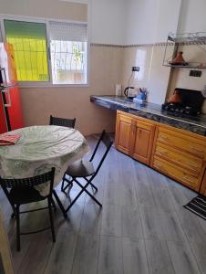 a kitchen with a table and chairs in a kitchen at tamraght samba 2 in Tamraght Ou Fella