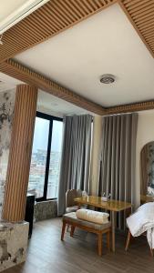a bedroom with a desk and a table in a room at Hotel oasis Sevilla Valle in Sevilla