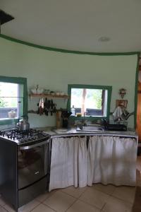 a kitchen with a stove and a sink at Cabaña Casa Morada in Futaleufú