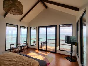 a bedroom with a bed and a view of the ocean at Bokanbotin Island Resort in Majuro