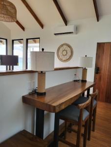 a wooden table with two lamps on it in a room at Bokanbotin Island Resort in Majuro