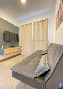 a bedroom with a bed and a flat screen tv at Refugio do Sol in Extrema