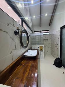 a bathroom with a sink and a mirror at Bokanbotin Island Resort in Majuro