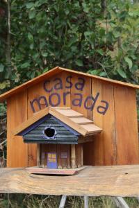 a wooden bird house sitting on top of a bench at Cabaña Casa Morada in Futaleufú