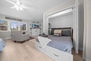 a bedroom with a bed and a chair at Private Poolside Guesthouse Suite! Prime Location! in Ocala +22 photos
