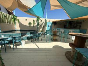 a patio with tables and chairs and a tent at La Vida Hostel Chiang Mai in Chiang Mai