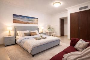 a bedroom with a large bed and a couch at Panoramic Sea apartment & Skyline View Private Room in Sharjah