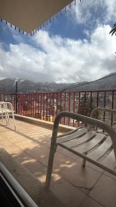 a bench sitting on top of a balcony at Faraya chalet in Fārayyā
