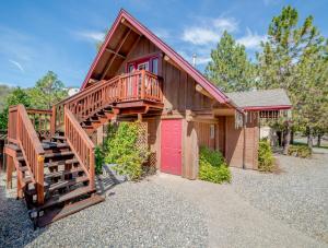 a house with a wooden staircase and a red door at Nature's Inn Bed and Breakfast in Ahwahnee