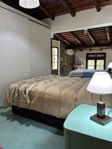 a bedroom with a bed and a table with a lamp at Villa Pellegrini in Trapiche +57 photos