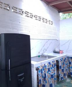 a kitchen with a sink and a refrigerator at BlueBayou.capurgana in Capurganá +122 photos