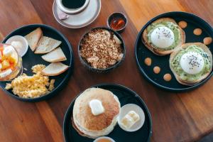 a wooden table topped with plates of breakfast foods at Casa de Mono Bocas in Big Creek