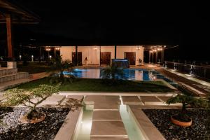 a resort with a swimming pool at night at Hotel Catleya Royal Club in Pereira