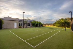 a tennis court in front of a house at Edgewater in Balnarring Beach