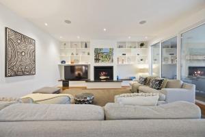 a living room with two couches and a fireplace at Edgewater in Balnarring Beach
