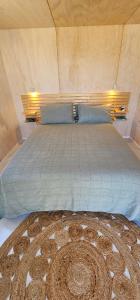 a bedroom with a large bed in a room at Kiwi Bach - Beachfront & Sunsets in Ahipara