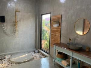 a bathroom with a sink and a mirror at Studio Thakhek-private loft with terasse in Thakhek +7 photos