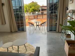 a room with tables and chairs and sliding glass doors at Studio Thakhek-private loft with terasse in Thakhek