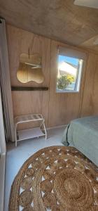 a bedroom with a bed and a window at Kiwi Bach - Beachfront & Sunsets in Ahipara +23 photos