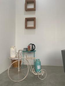 a table with a cart next to a wall at Studio Thakhek-private loft with terasse in Thakhek