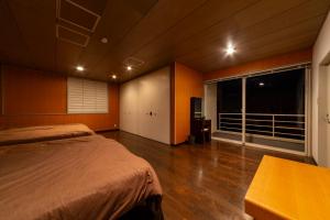 a bedroom with a bed and a large window at セト ヴィスタ 牛窓 in Setouchi +31 photos