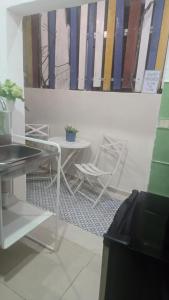 a table and chairs in a room with a painting at Colonial apartment for up to 4 person in Santo Domingo