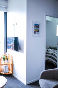 a living room with a chair and a window at Top Floor - Secure Parking - Great Location - Quiet - City Ciew in Wellington