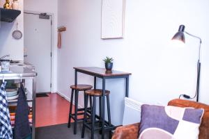 a living room with a table and stools at Top Floor - Secure Parking - Great Location - Quiet - City Ciew in Wellington