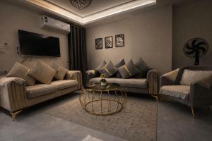 a living room with two couches and a table at Star Luka in Luxor