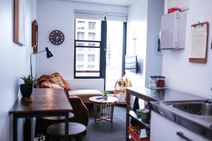 a living room with a couch and a table at Top Floor - Secure Parking - Great Location - Quiet - City Ciew in Wellington